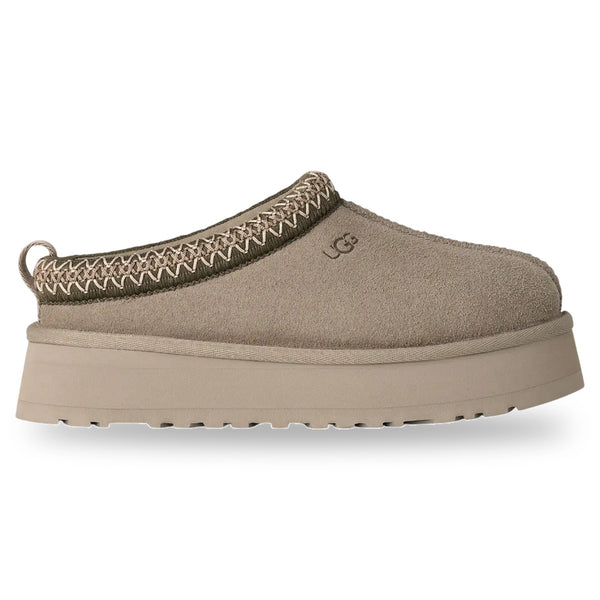 Beige slip-on shoe with platform sole on a white background