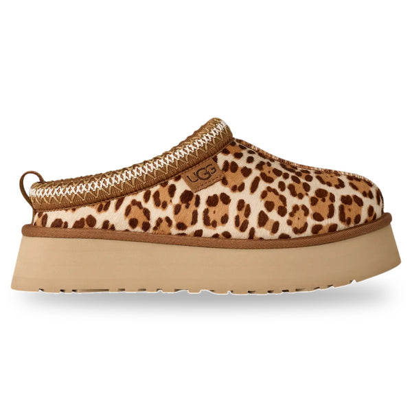 Leopard print slip-on shoe with a beige platform sole on a white background