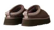 Brown slippers with textured straps on a white background