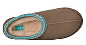 Brown UGG slipper with turquoise trim on a white background