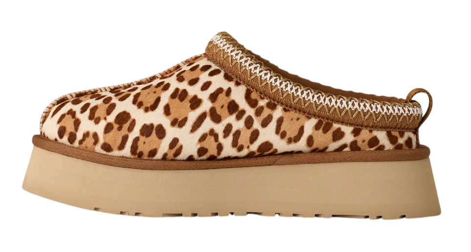 Leopard print slip-on shoe with a brown sole on a white background