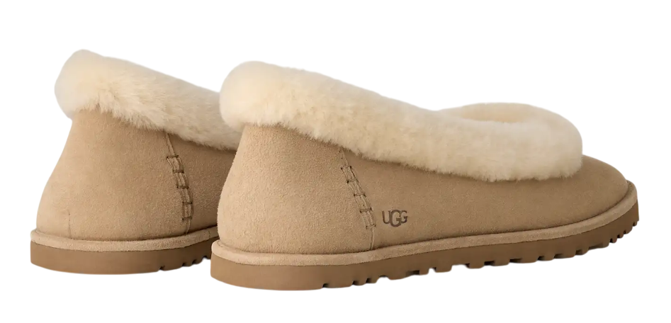 Pair of tan UGG slippers with sheepskin lining on a white background