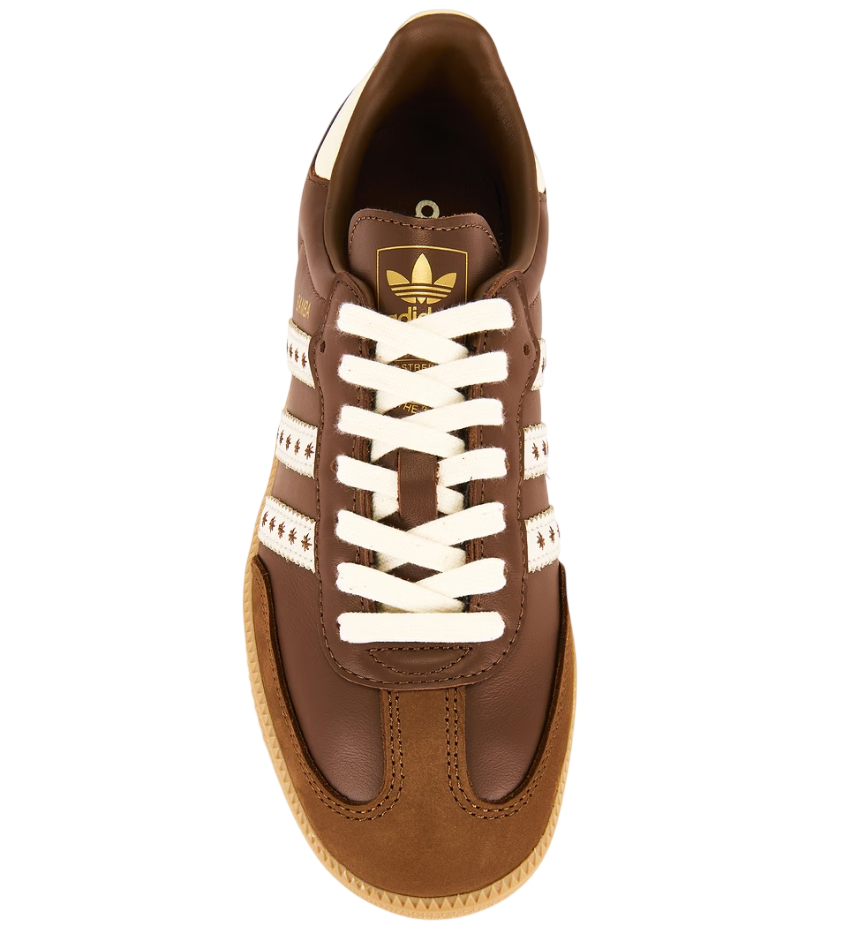 Brown Adidas sneaker with white laces on a white background