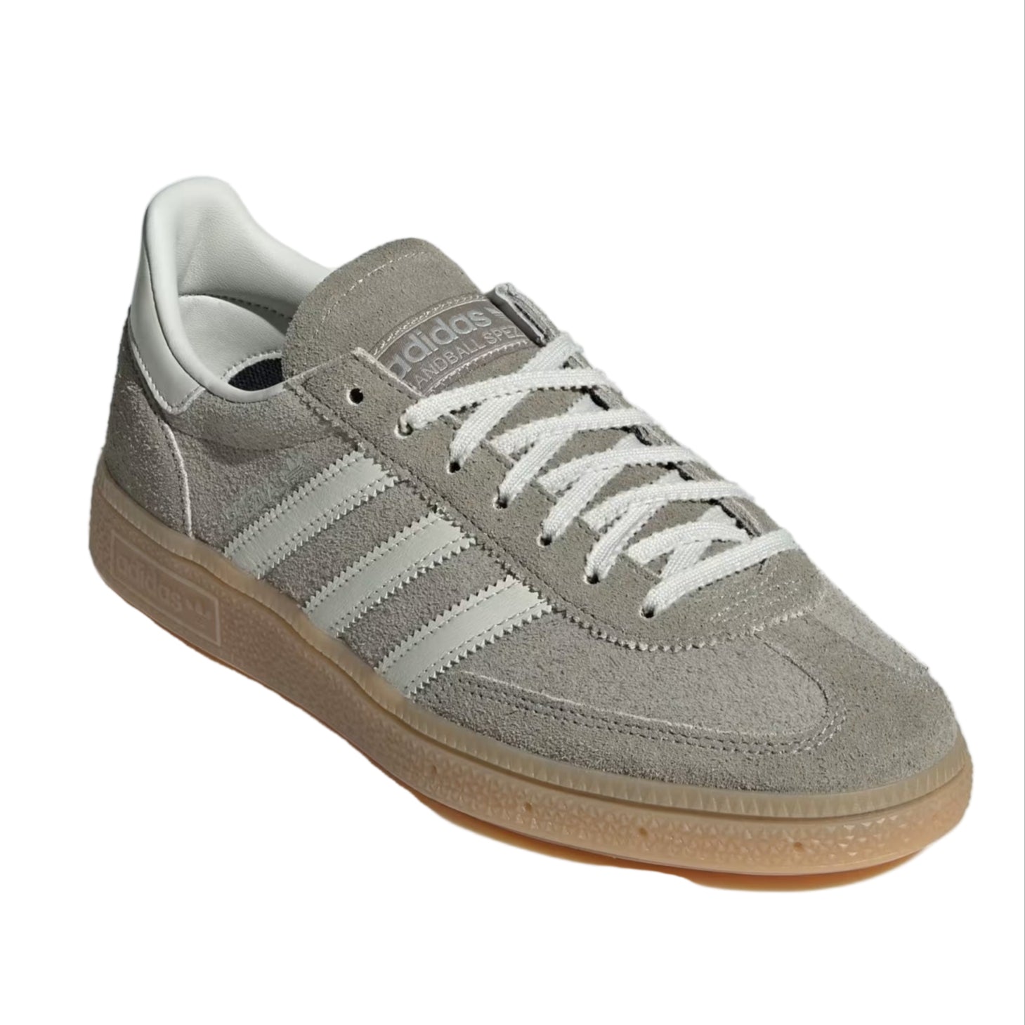 Gray Adidas sneaker with white stripes on a light gray background