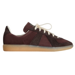 Brown sneaker with white laces on a light gray background - Image 1