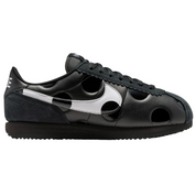Black sneaker with white accents on a white background