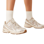 Beige sneakers worn with white socks on a white background - Image 2