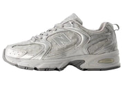 Gray athletic shoe with New Balance logo on a white background