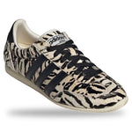 Adidas sneaker with tiger stripe pattern on a white background - Image 2