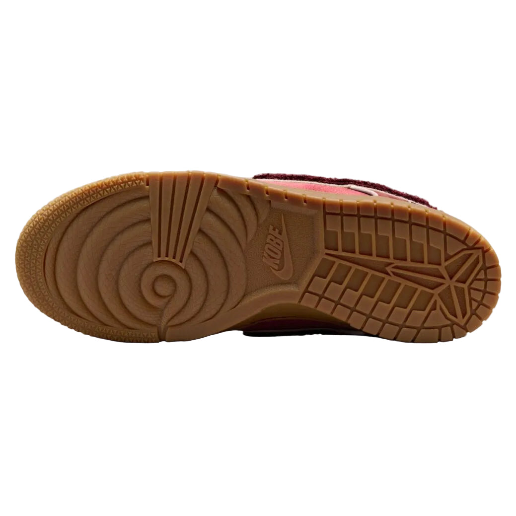 Close-up of a brown sneaker sole with brand logo on a white background