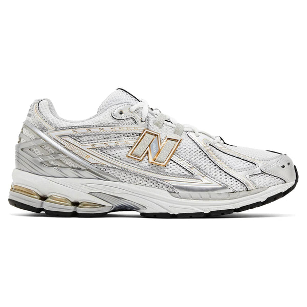 White athletic shoe with gold accents on a white background
