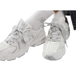 White sneakers worn with white socks on a white background - Image 5