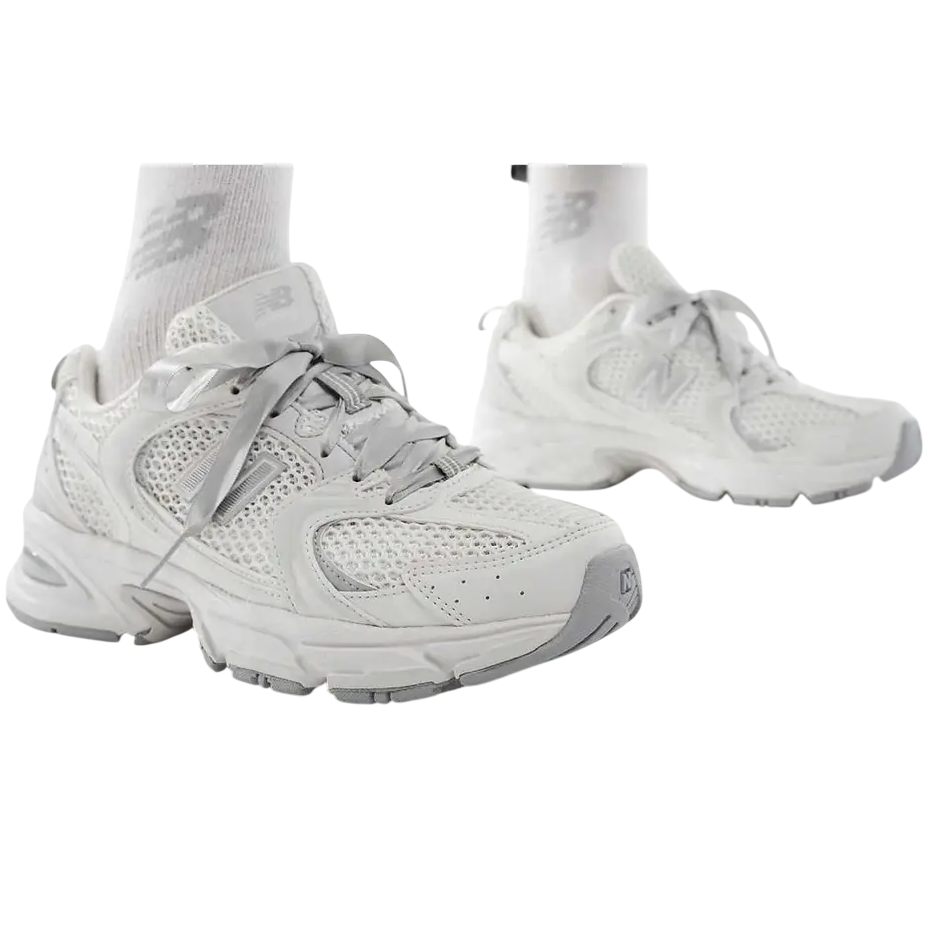 White sneakers worn with white socks on a white background