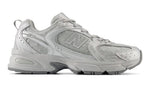 Gray sneaker with New Balance logo on a white background - Image 1