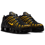 Black and yellow athletic shoes on a white background - Image 2