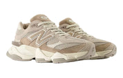 Pair of beige New Balance sneakers on a white background