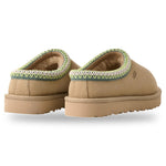 Pair of tan slippers with green trim on a white background - Image 2